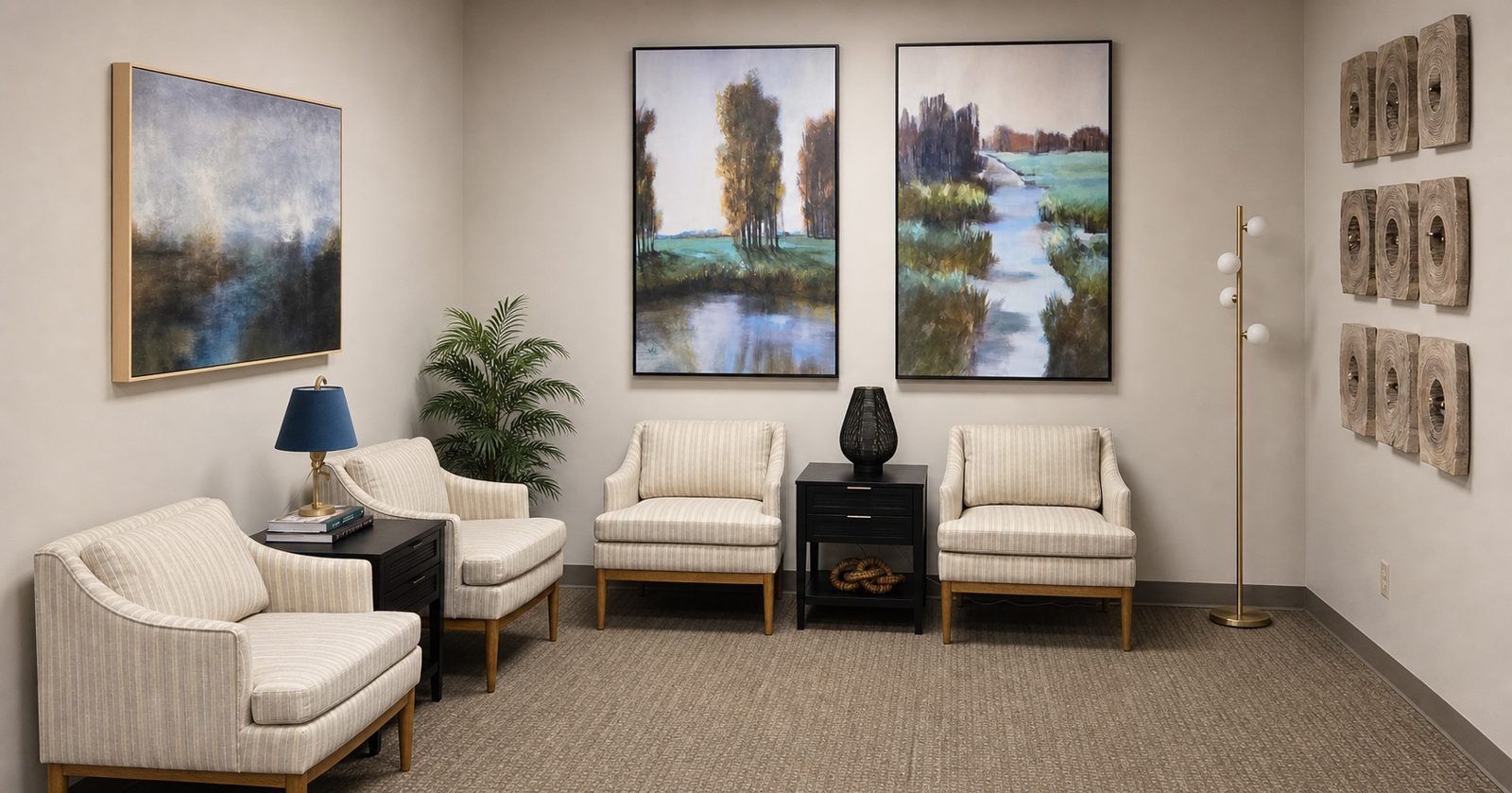 Waiting area with armchairs and landscape paintings